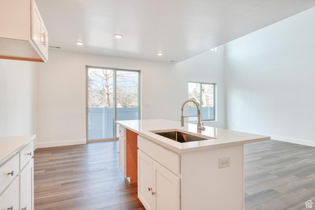 241 E 100 N Unit 3, Moab, UT 84532 - kitchen with an island with sink, sink, white cabinets, and light wood-type flooring