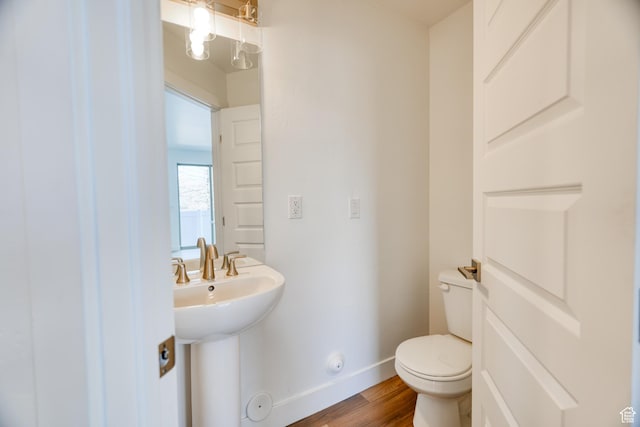 241 E 100 N Unit 3, Moab, UT 84532 - bathroom with sink, toilet, and hardwood / wood-style floors