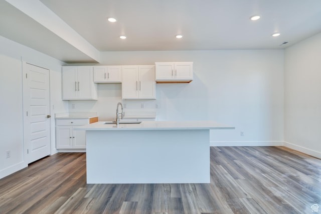 241 E 100 N Unit 3, Moab, UT 84532 - kitchen with hardwood / wood-style floors, white cabinetry, a kitchen island with sink, and sink