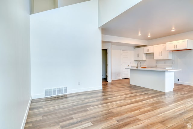 241 E 100 N Unit 3, Moab, UT 84532 - kitchen featuring sink, light hardwood / wood-style flooring, and white cabinets
