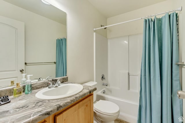 full bathroom with vanity, shower / tub combo, and toilet