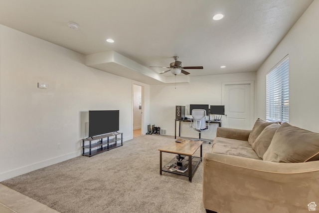 living room featuring light carpet and ceiling fan