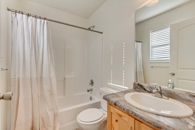 full bathroom with vanity, toilet, and shower / bath combo with shower curtain
