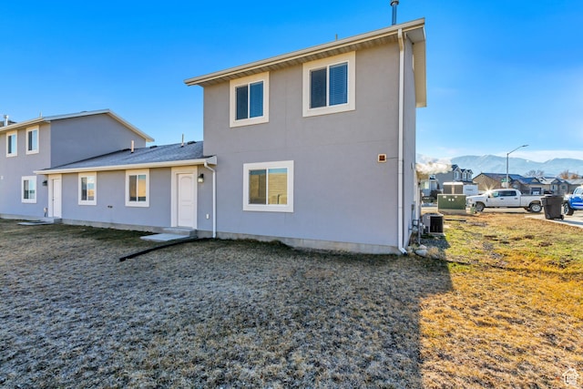 back of property featuring central AC and a mountain view