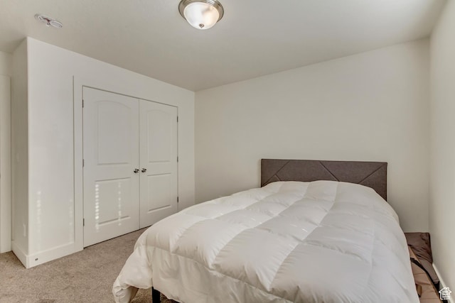 carpeted bedroom with a closet