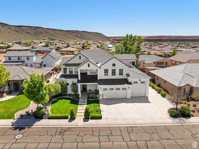 birds eye view of property with a residential view and a mountain view