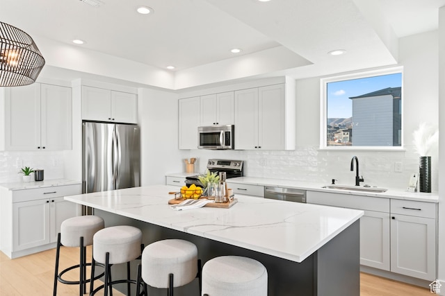 113 E Watson Dr S, Saratoga Springs, UT 84045 - kitchen with white cabinetry, stainless steel appliances, a center island, and sink