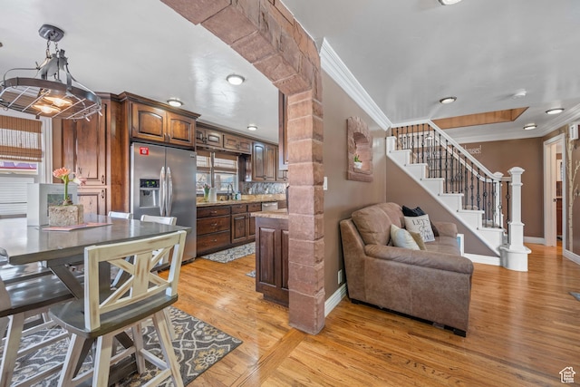 75 N 200 W, Kanab, UT 84741 - kitchen with crown molding, stainless steel fridge, and light hardwood / wood-style floors