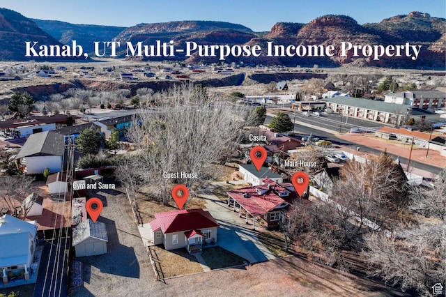 birds eye view of property with a mountain view