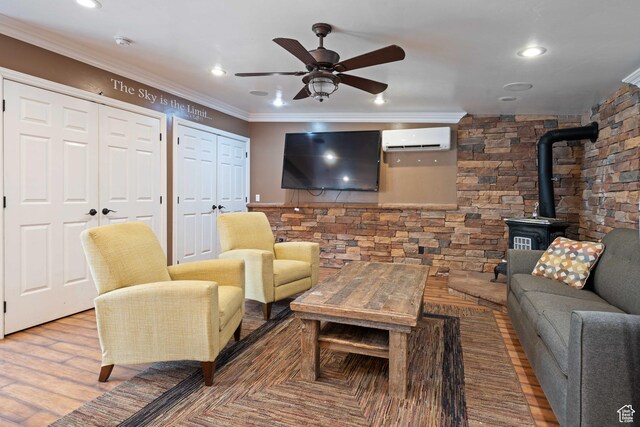 75 N 200 W, Kanab, UT 84741 - living room with hardwood / wood-style flooring, ceiling fan, a wall mounted air conditioner, ornamental molding, and a wood stove