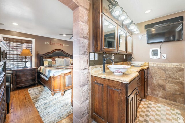 75 N 200 W, Kanab, UT 84741 - bathroom featuring ornate columns, wood-type flooring, tile walls, vanity, and ceiling fan
