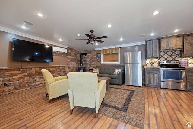 75 N 200 W, Kanab, UT 84741 - living room with ornamental molding, light hardwood / wood-style flooring, a wall unit AC, and a wood stove