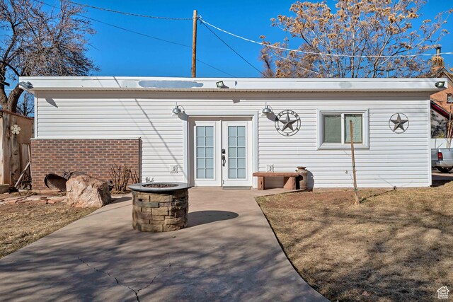 75 N 200 W, Kanab, UT 84741 - rear view of house featuring a patio, a fire pit, french doors, and a yard