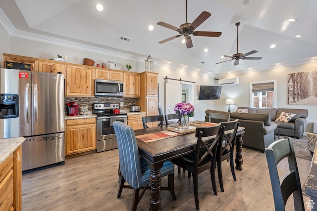 75 N 200 W, Kanab, UT 84741 - dining area with lofted ceiling, a barn door, a wall unit AC, and light hardwood / wood-style flooring