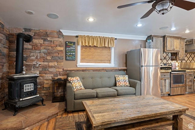 75 N 200 W, Kanab, UT 84741 - living room with hardwood / wood-style flooring, crown molding, a wood stove, and ceiling fan