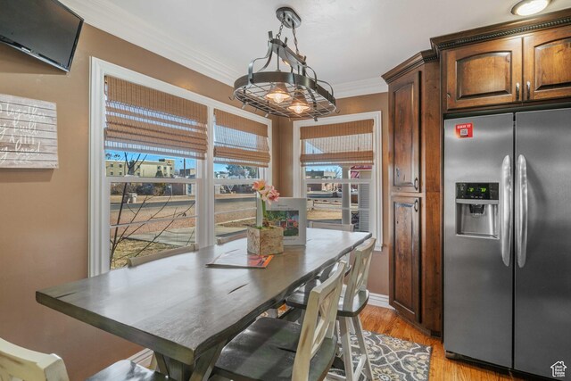 75 N 200 W, Kanab, UT 84741 - dining space featuring crown molding and light hardwood / wood-style flooring