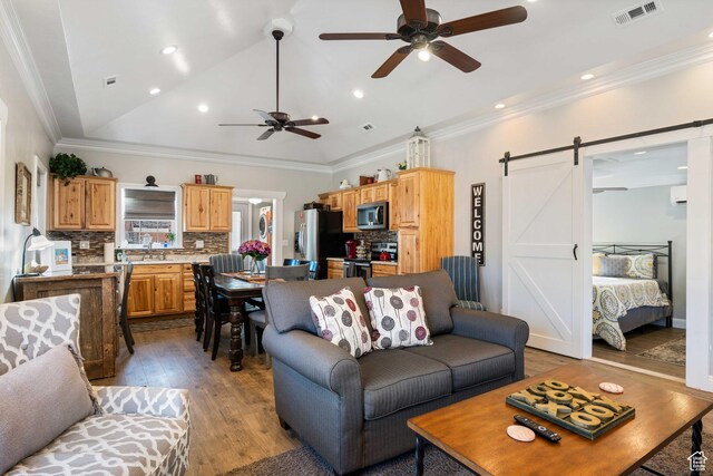 75 N 200 W, Kanab, UT 84741 - living room featuring vaulted ceiling, ceiling fan, light hardwood / wood-style floors, crown molding, and a barn door