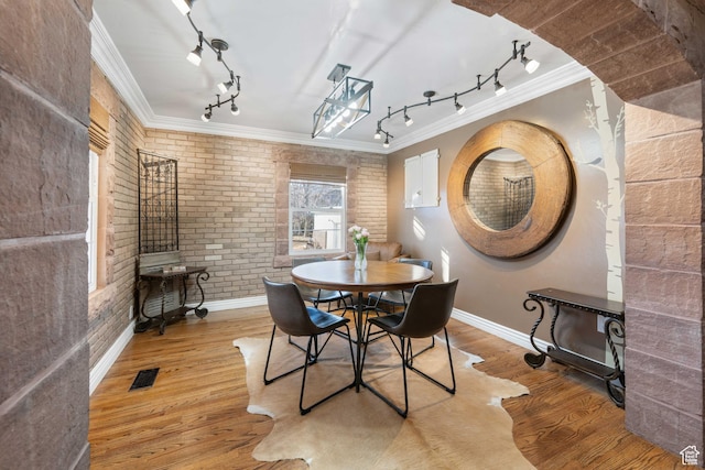 75 N 200 W, Kanab, UT 84741 - dining area with hardwood / wood-style flooring, ornamental molding, and brick wall