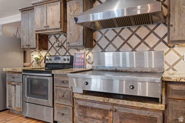 75 N 200 W, Kanab, UT 84741 - kitchen featuring appliances with stainless steel finishes, backsplash, ornamental molding, light hardwood / wood-style floors, and wall chimney exhaust hood