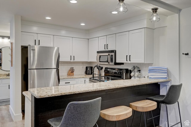 407 S Vasels Rd Unit 8, Brian Head, UT 84719 - kitchen with white cabinetry, stainless steel appliances, and light stone countertops