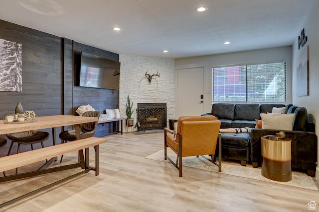 407 S Vasels Rd Unit 8, Brian Head, UT 84719 - living room featuring a textured ceiling, light hardwood / wood-style floors, and a fireplace
