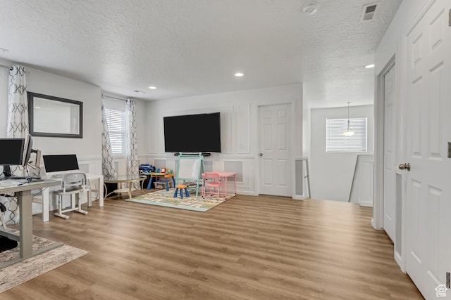739 W Wild Hyacinth Dr, Saratoga Springs, UT 84045 - living room with light hardwood / wood-style floors and a textured ceiling