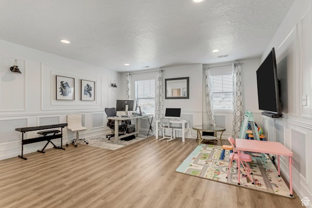 739 W Wild Hyacinth Dr, Saratoga Springs, UT 84045 - home office with a textured ceiling, a wealth of natural light, and wood-type flooring