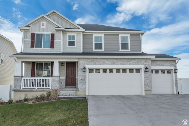 craftsman-style house featuring a garage, a porch, and a front lawn