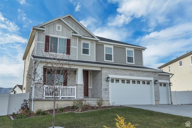 739 W Wild Hyacinth Dr, Saratoga Springs, UT 84045 - craftsman house featuring a garage, a front lawn, and covered porch