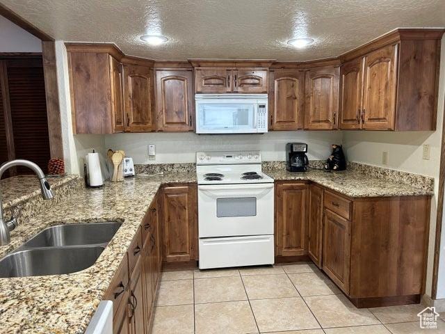 150 W Ridge View St Unit 241, Brian Head, UT 84719 - kitchen with sink, white appliances, light stone counters, a textured ceiling, and light tile patterned flooring