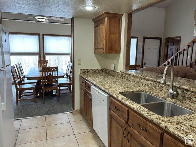 150 W Ridge View St Unit 241, Brian Head, UT 84719 - kitchen featuring sink, light tile patterned floors, white appliances, light stone counters, and a textured ceiling
