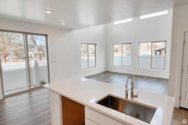 241 E 100 N Unit 4, Moab, UT 84532 - kitchen with sink, light hardwood / wood-style floors, and white cabinets