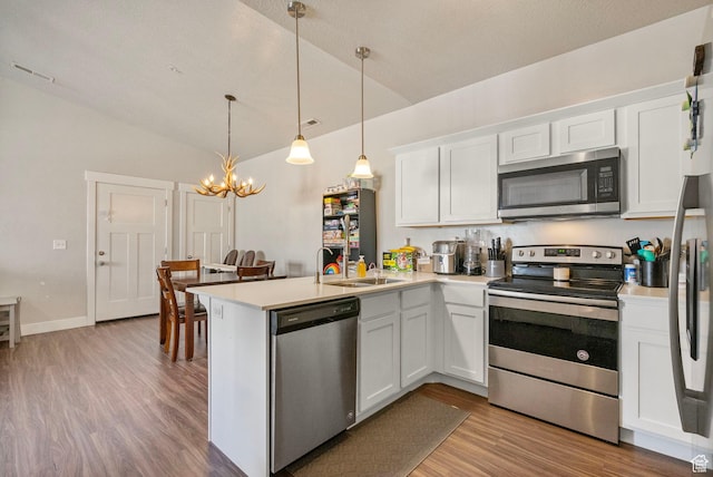 1772 W Tera Vista Ln Unit G302, Saratoga Springs, UT 84045 - kitchen featuring sink, white cabinetry, hanging light fixtures, kitchen peninsula, and stainless steel appliances