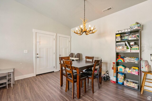 1772 W Tera Vista Ln Unit G302, Saratoga Springs, UT 84045 - dining space featuring dark wood-type flooring, lofted ceiling, and a notable chandelier