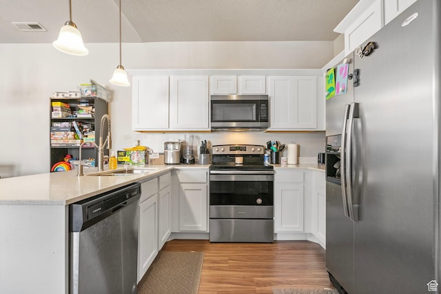1772 W Tera Vista Ln Unit G302, Saratoga Springs, UT 84045 - kitchen with hanging light fixtures, white cabinetry, appliances with stainless steel finishes, and kitchen peninsula