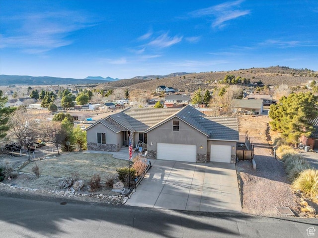 ranch-style home with a mountain view and a garage