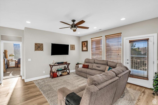 living room featuring ceiling fan and light wood-type flooring