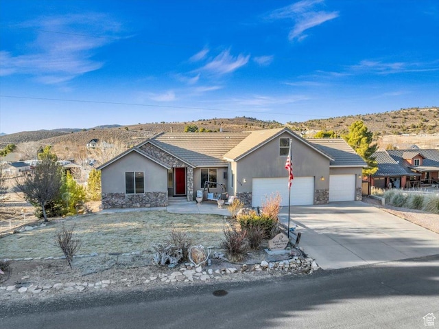 ranch-style house with a garage and a mountain view