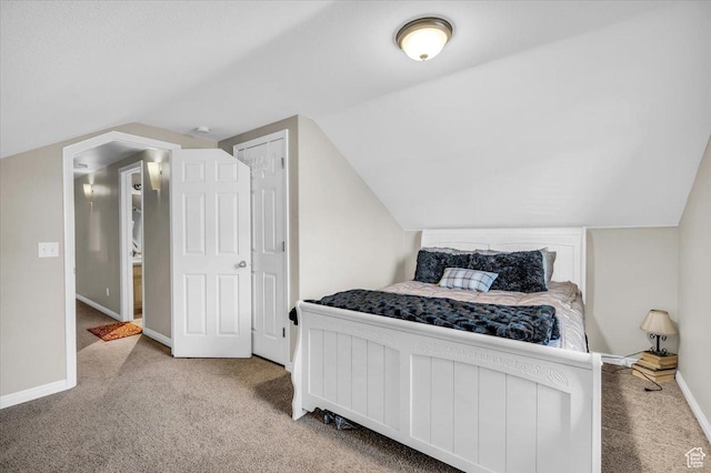 bedroom featuring lofted ceiling and carpet floors