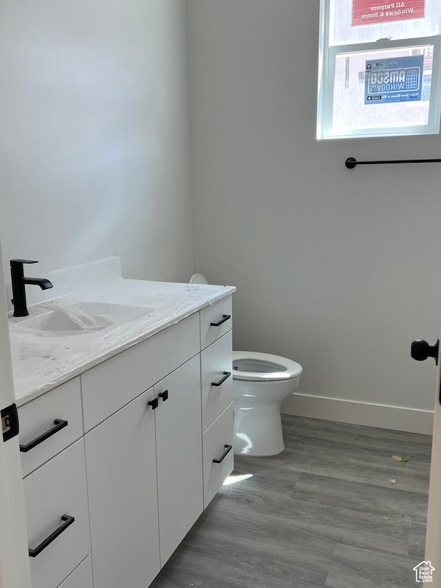 344 W Rosie Loop Unit 46E, Cedar City, UT 84721 - bathroom featuring vanity, toilet, baseboards, and wood finished floors