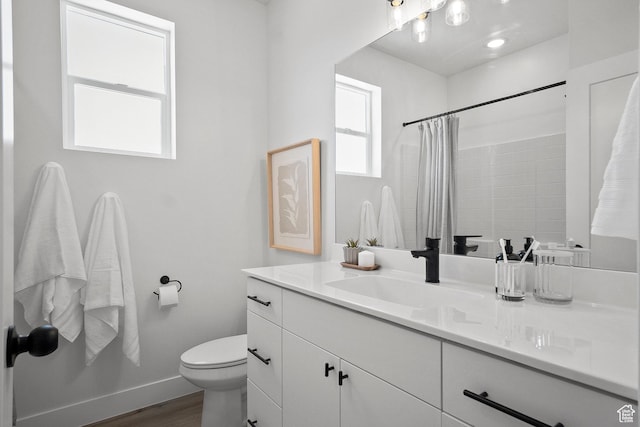 344 W Rosie Loop Unit 46E, Cedar City, UT 84721 - bathroom featuring wood finished floors, toilet, vanity, and a shower with curtain