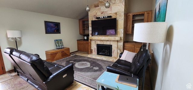 living room with lofted ceiling and a large fireplace