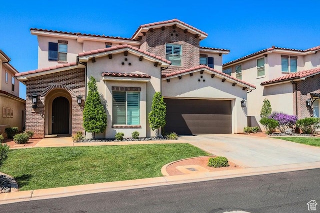 mediterranean / spanish house featuring a garage and a front lawn