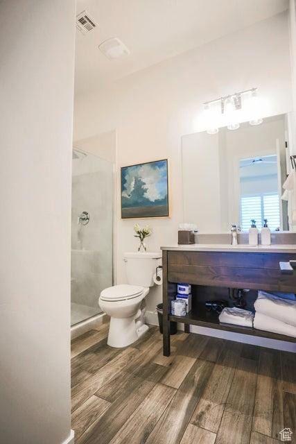 3780 Arcadia Dr Unit 51, Santa Clara, UT 84765 - bathroom featuring vanity, hardwood / wood-style floors, a shower with shower door, and toilet