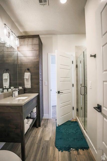 3780 Arcadia Dr Unit 51, Santa Clara, UT 84765 - bathroom featuring wood-type flooring, an enclosed shower, and vanity