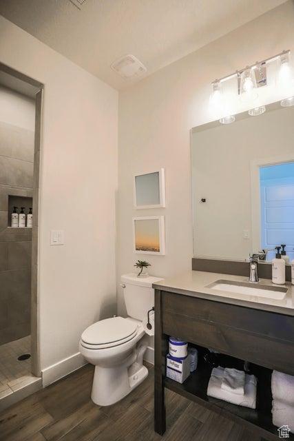 3780 Arcadia Dr Unit 51, Santa Clara, UT 84765 - bathroom with hardwood / wood-style flooring, vanity, toilet, and a tile shower