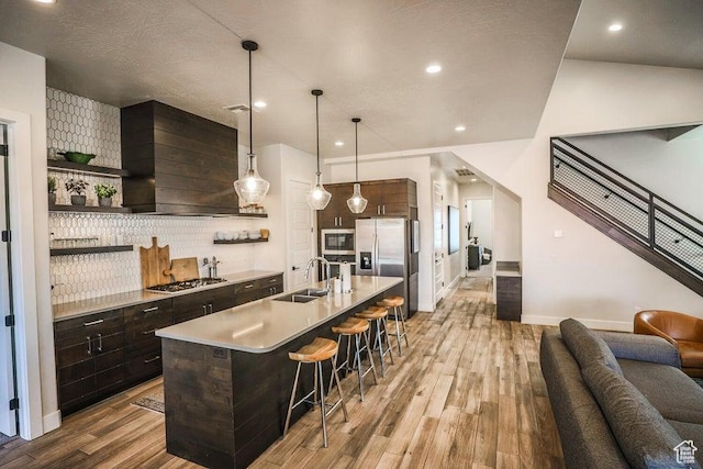 3780 Arcadia Dr Unit 51, Santa Clara, UT 84765 - kitchen with a kitchen bar, sink, hanging light fixtures, an island with sink, and stainless steel appliances