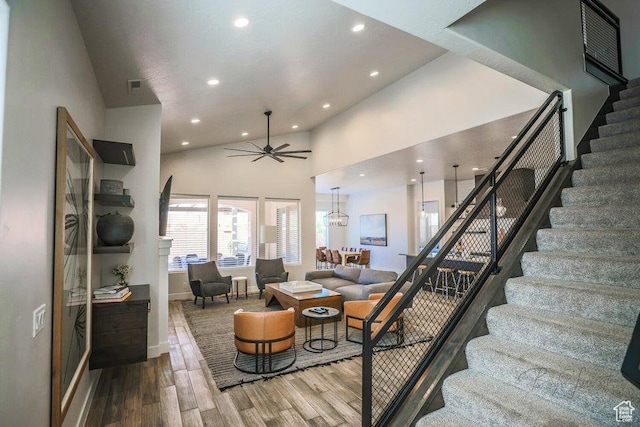 3780 Arcadia Dr Unit 51, Santa Clara, UT 84765 - living room with wood-type flooring, ceiling fan with notable chandelier, and high vaulted ceiling