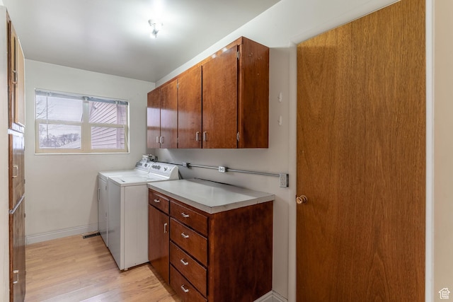 washroom with cabinets and light wood-type flooring