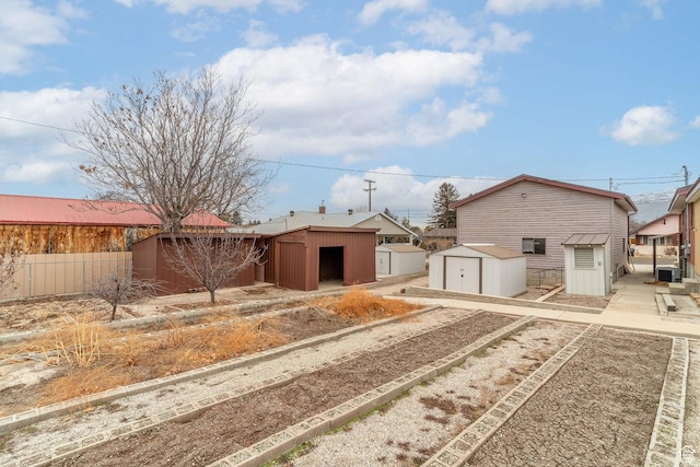view of front of home with a storage shed and central AC